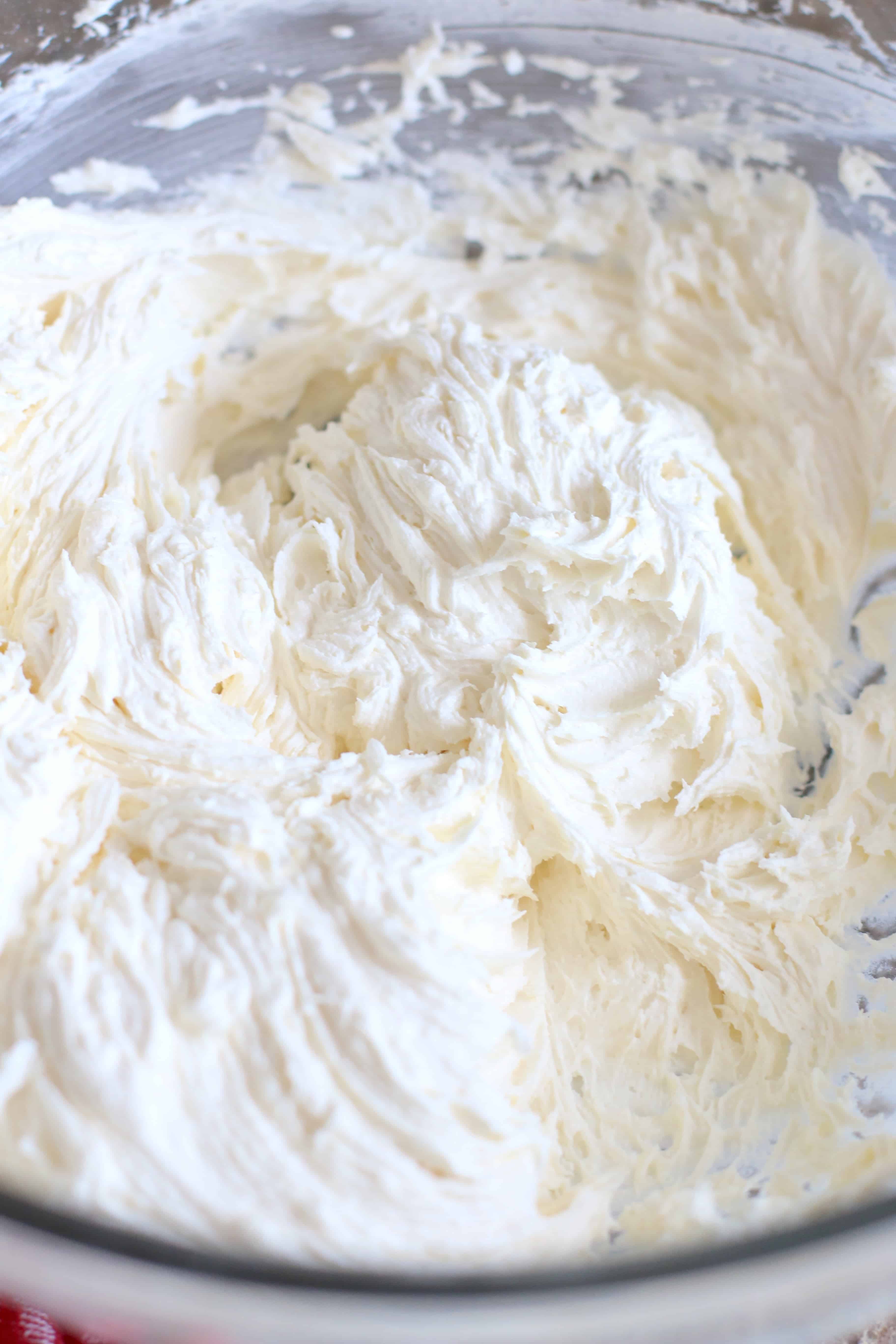marshmallow fluff frosting whipped together in a mixing bowl.