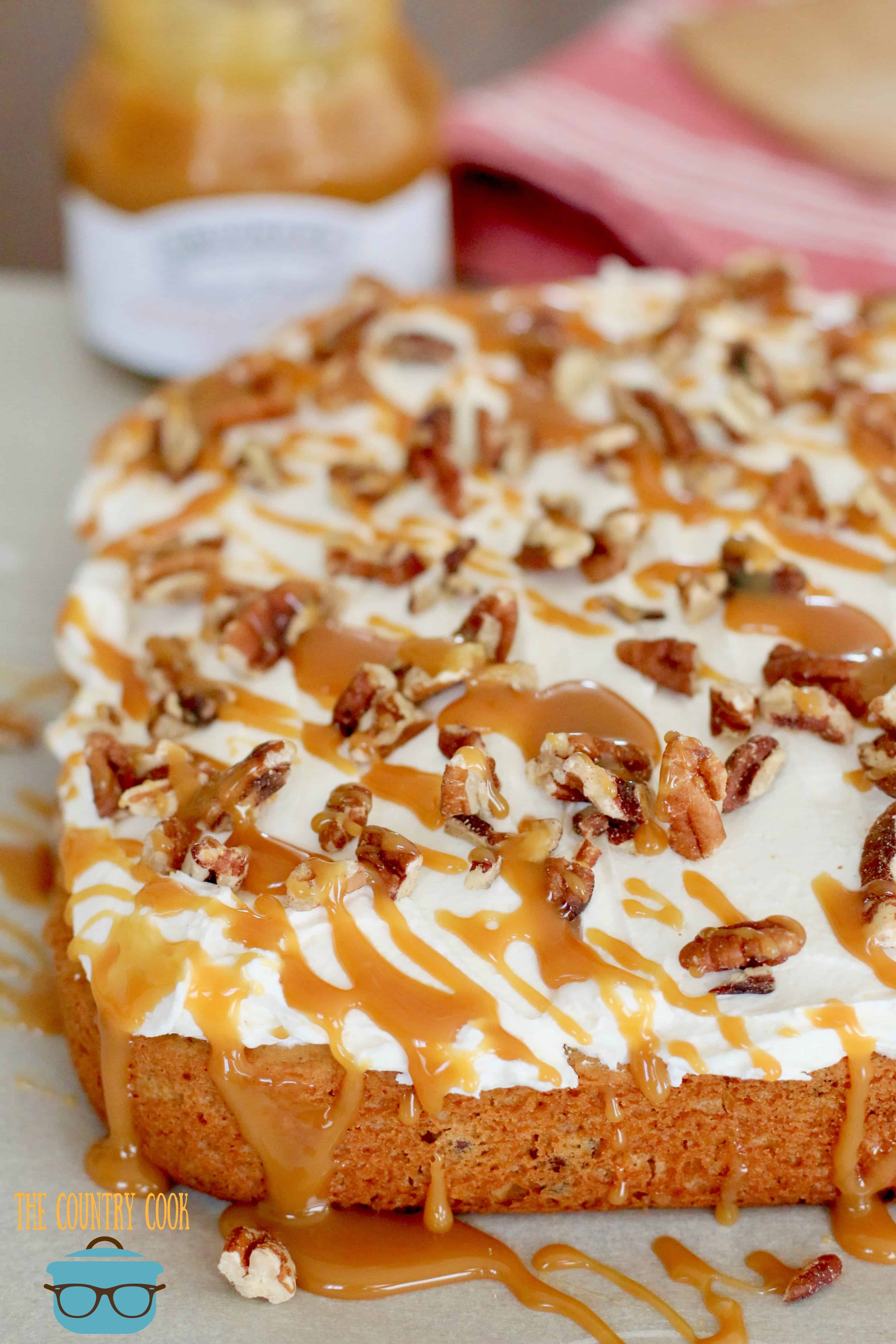 Sweet Potato/Pumpkin muffin mix cake topped with marshmallow frosting and caramel sauce shown close up.
