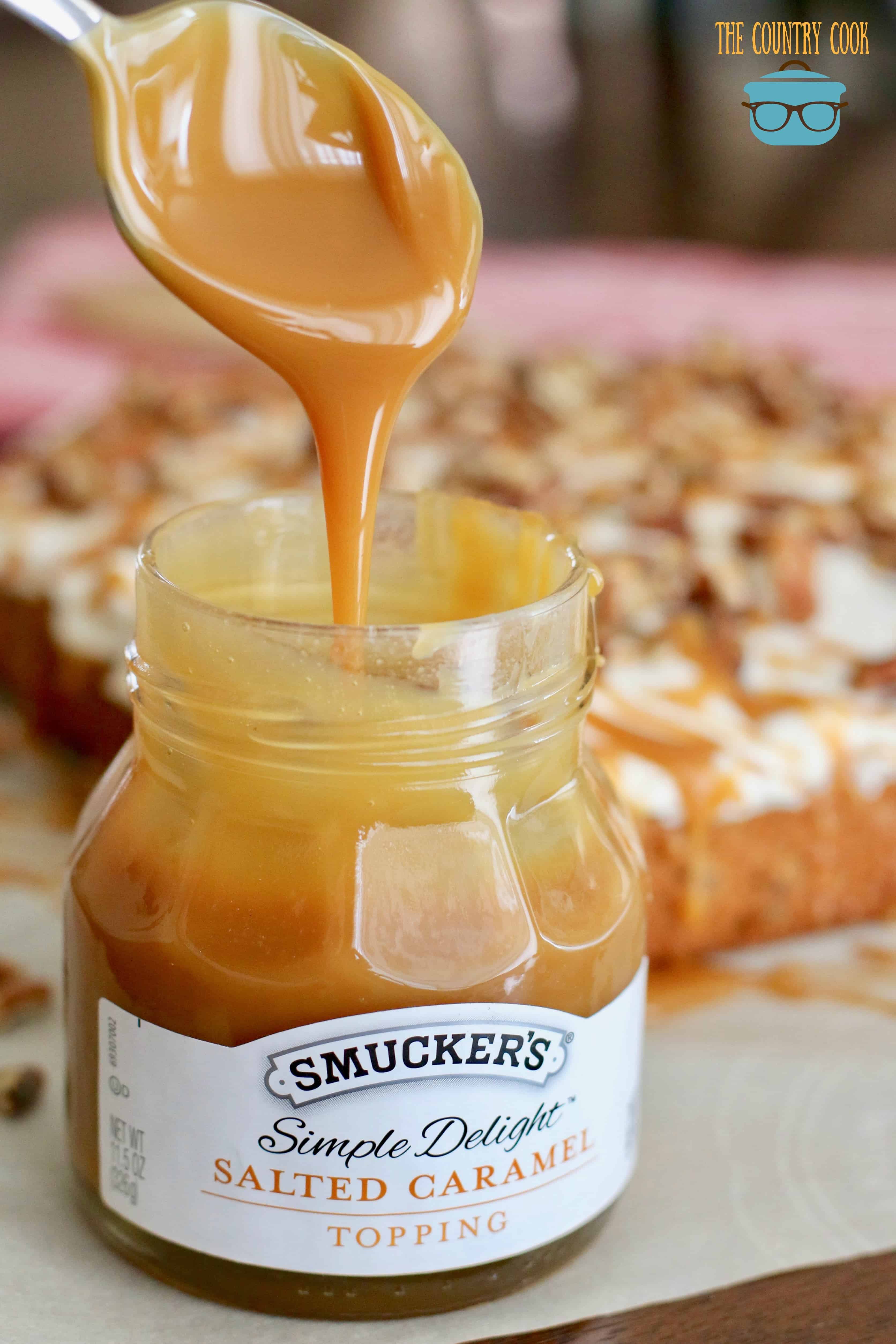 Smucker's Salted Caramel sauce being drizzled with a spoon.
