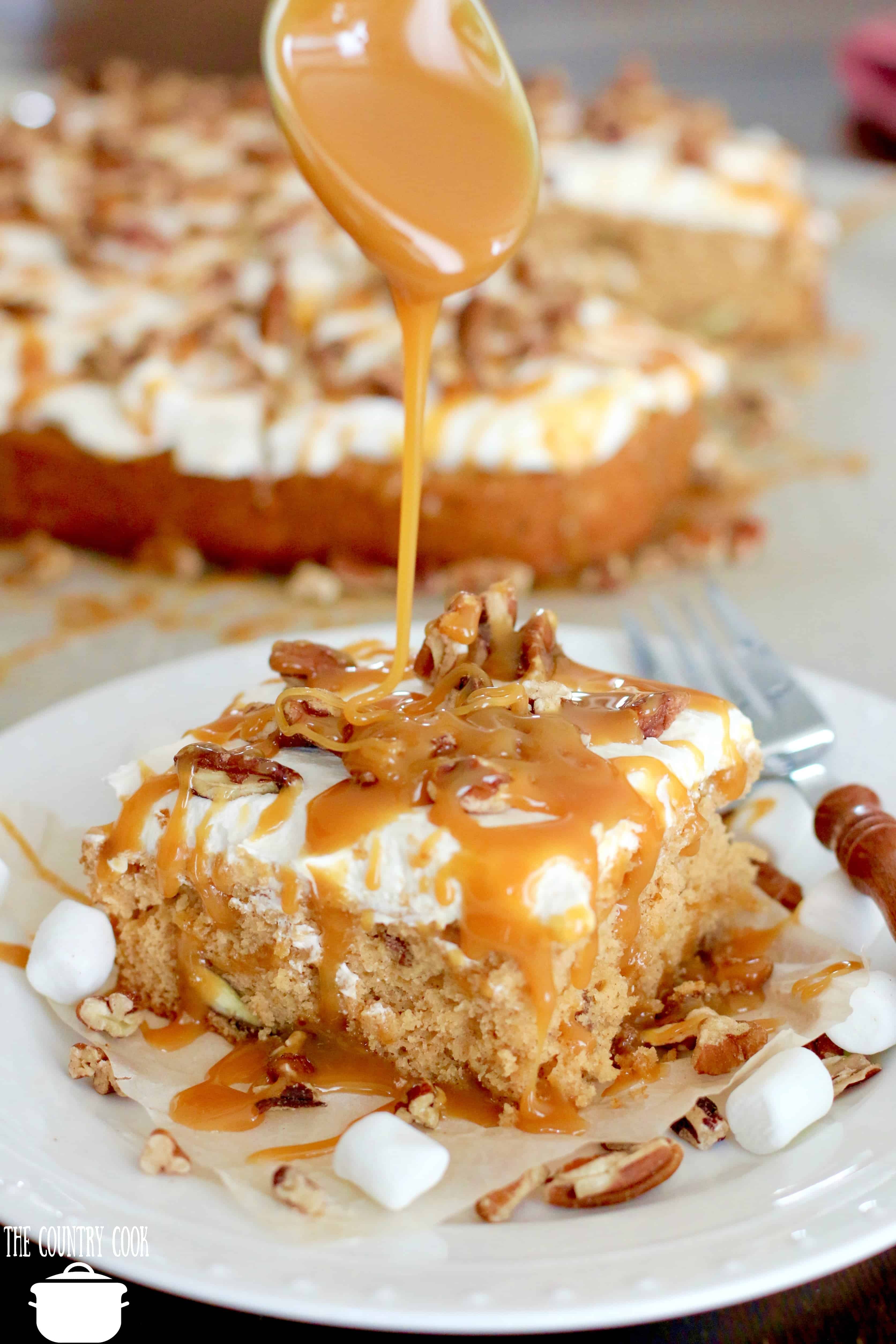 Muffin Mix Cake with chopped pecans and salted caramel. Spoon shown drizzling caramel on top of cake.