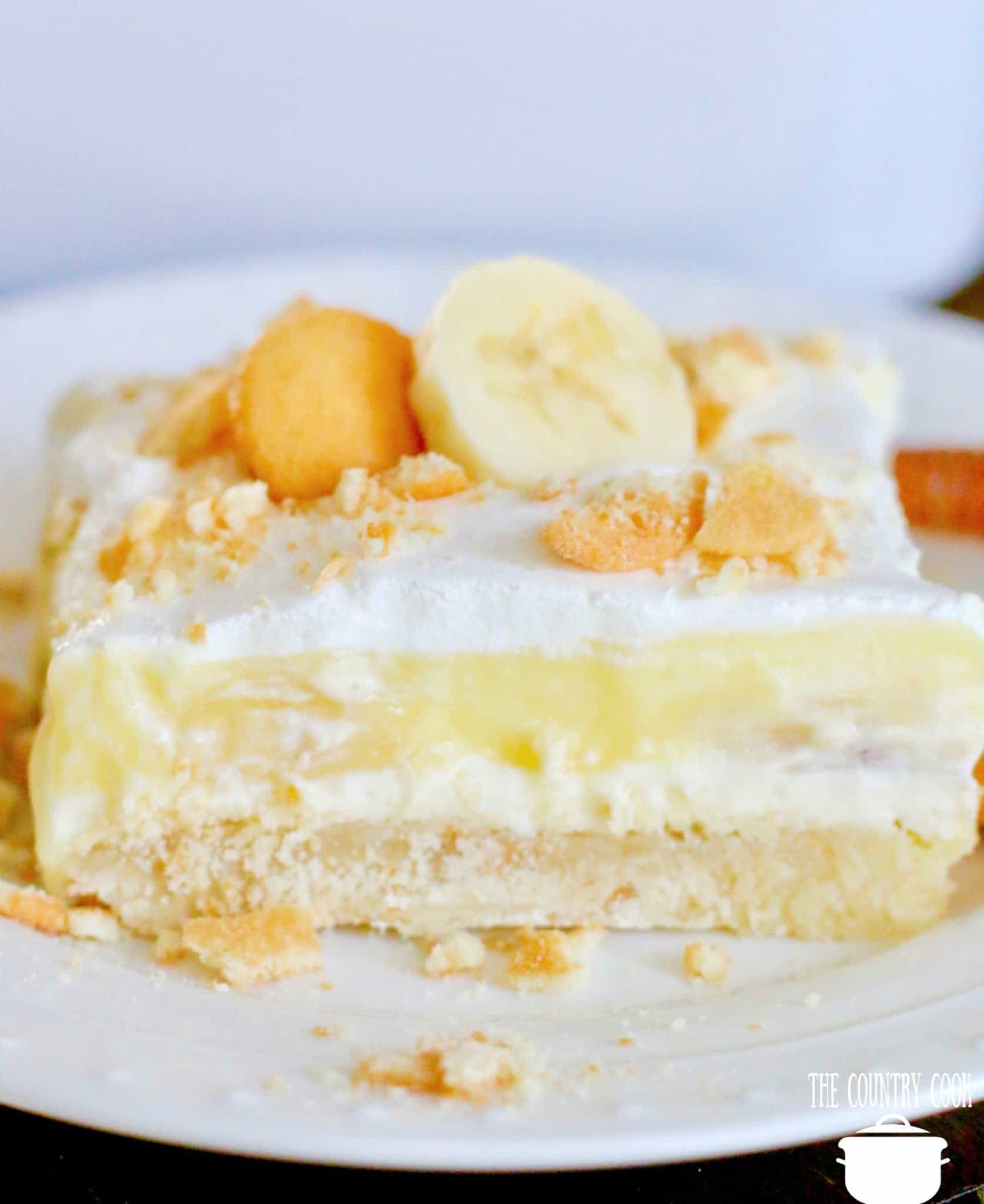 slice of banana cream pie delight showed on a round white plate. 