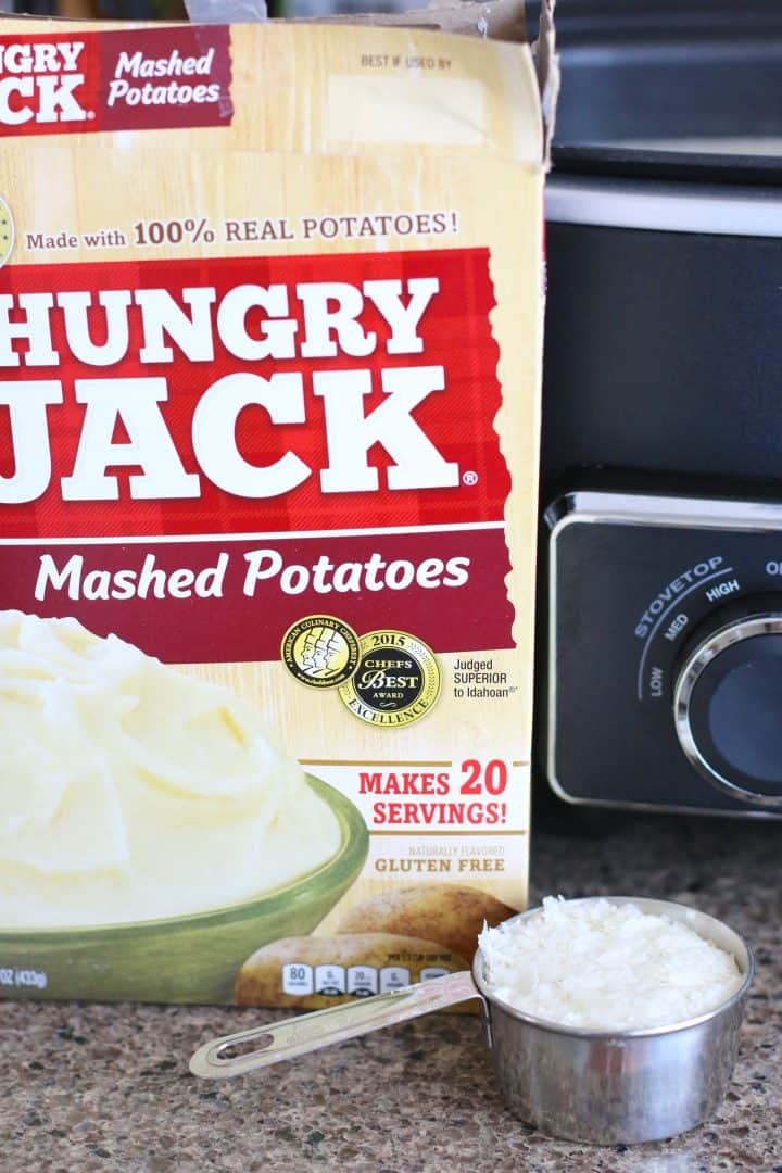 Instant potato flakes box in front of slow cooker. 