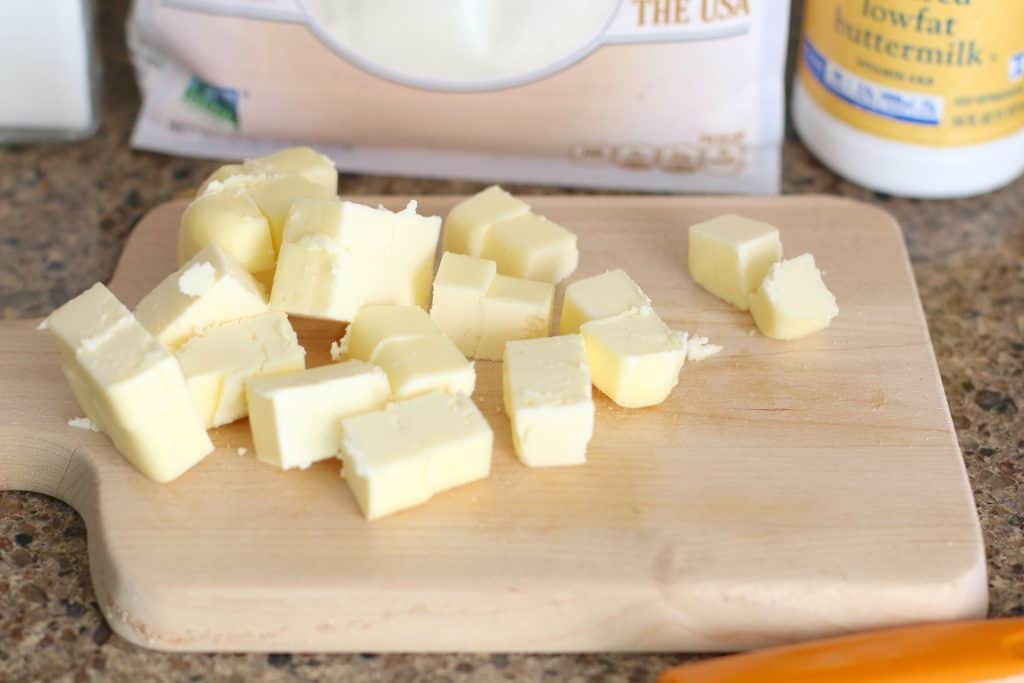 cubed butter on a wooden platter.