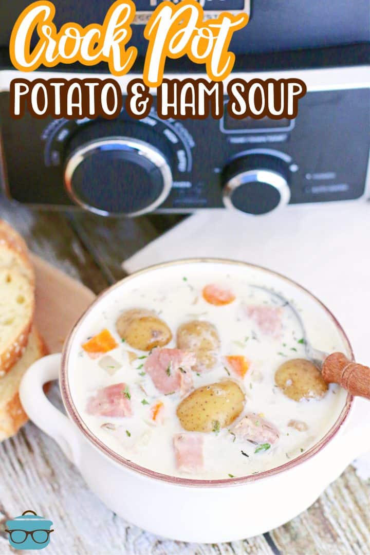 Crock Pot Creamy Potato and Ham Soup shown in a bowl in front of a black slow cooker.
