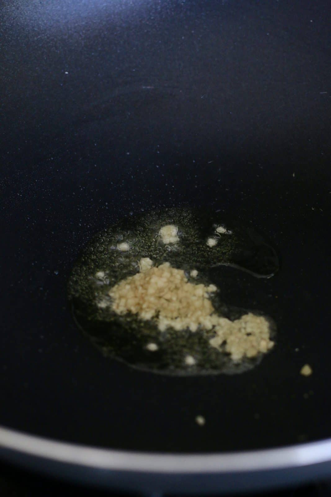 garlic in oil in a wok.