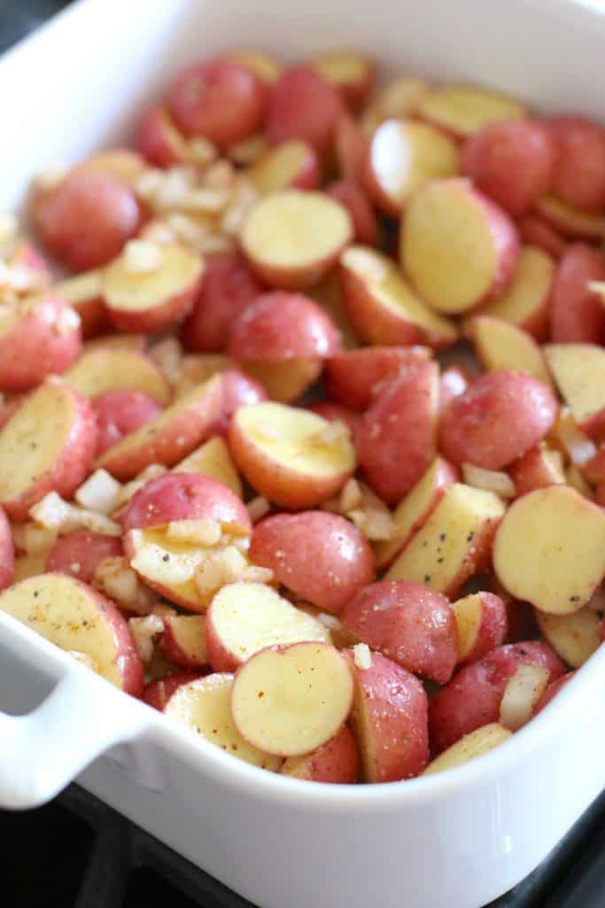 seasoned, sliced baby red Little Potatoes in a white Revol baking dish