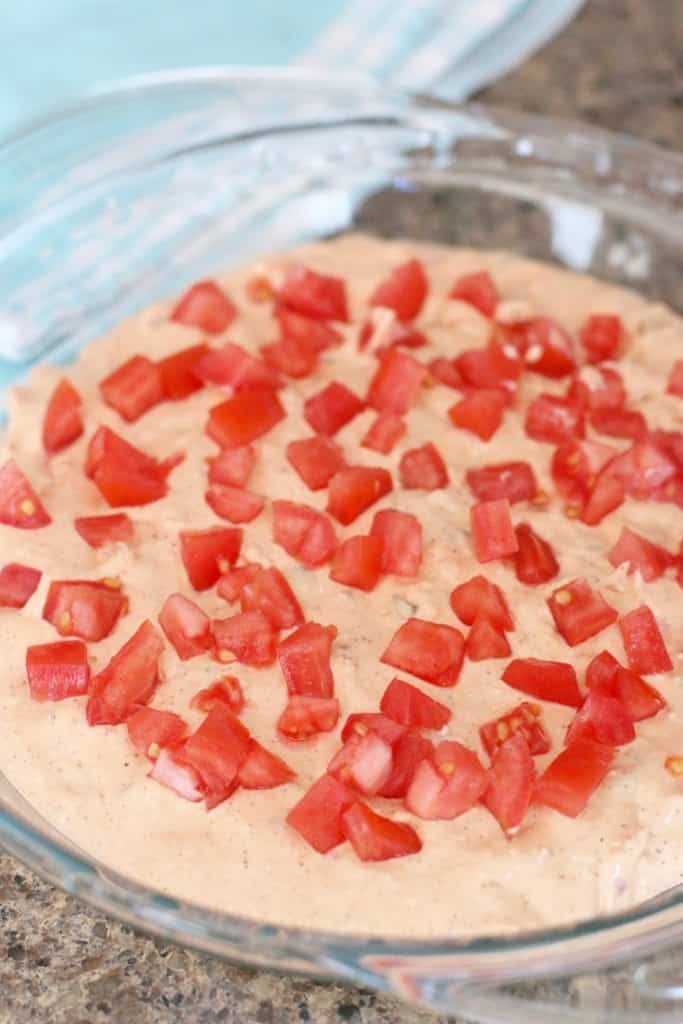 creamy dip mixture topped with chopped tomatoes