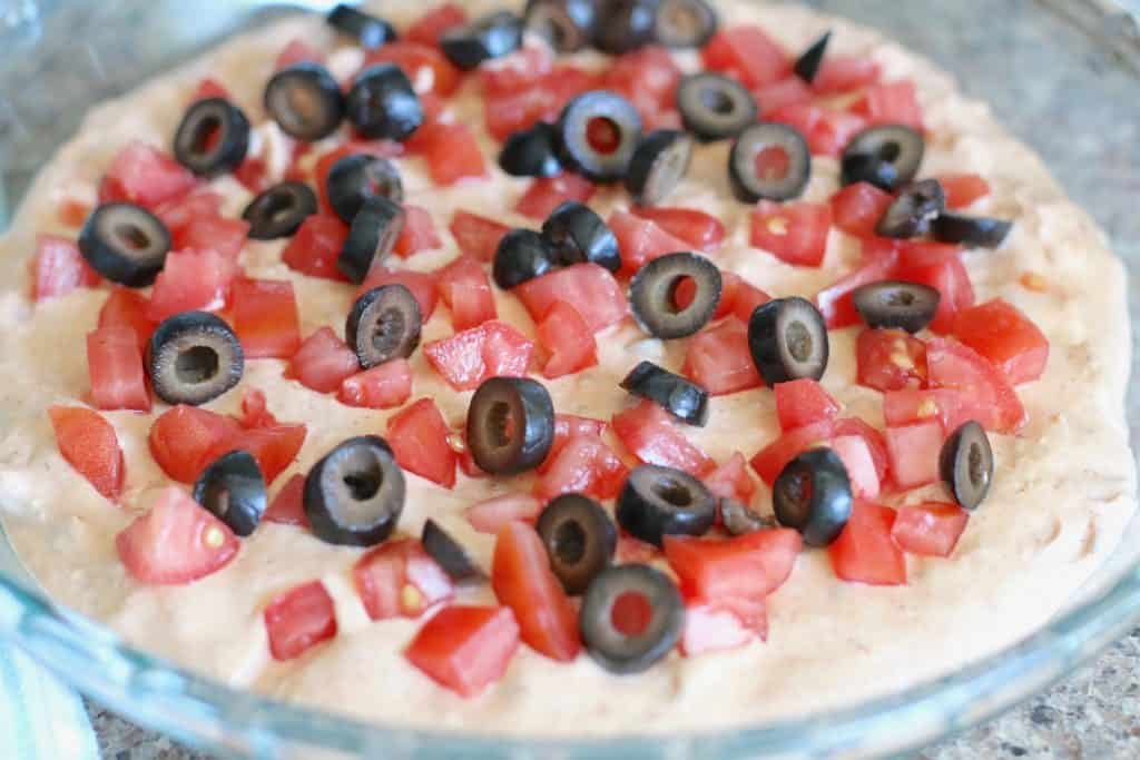 sliced olives and tomatoes added to dip mixture