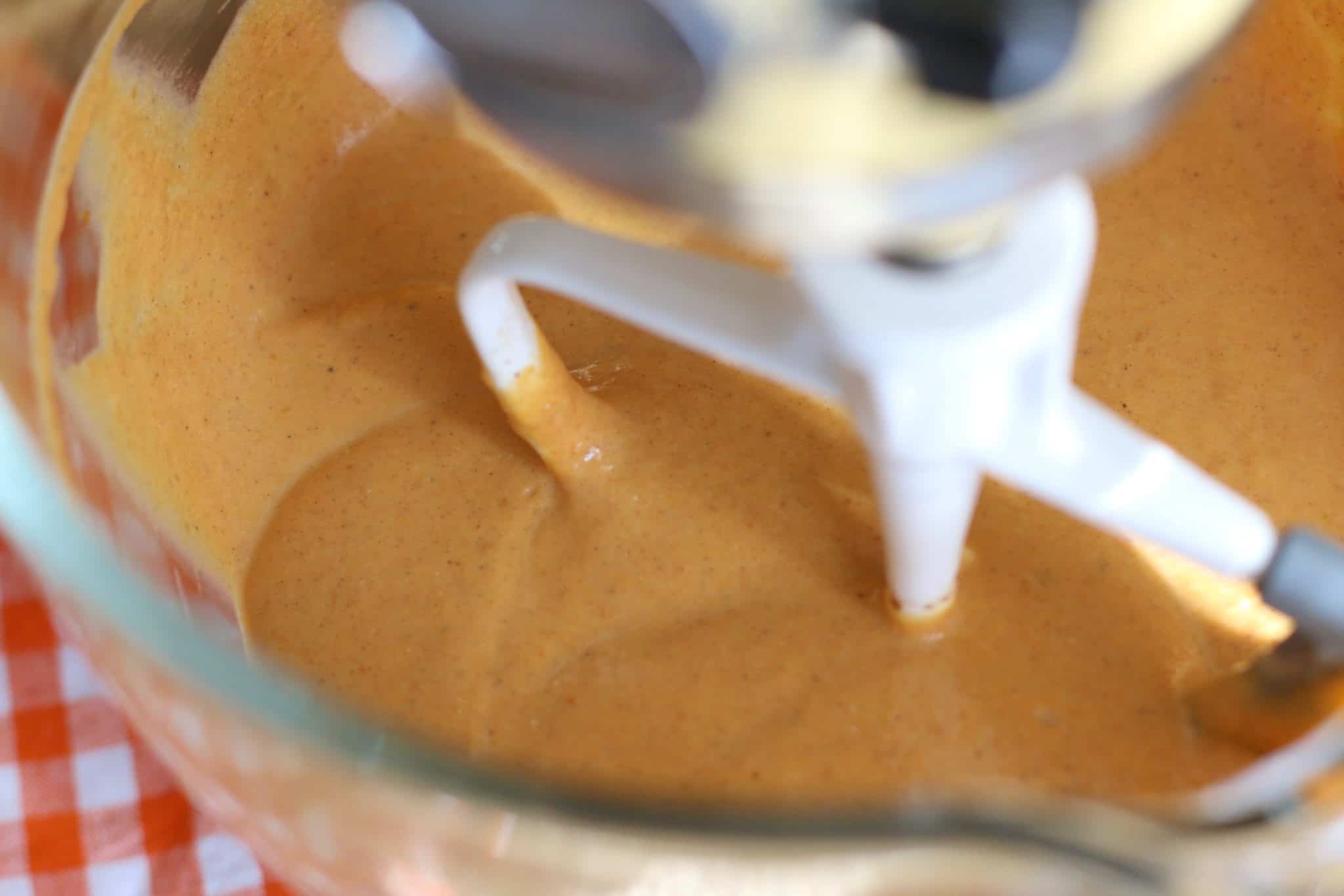 pumpkin pie filling mixed together in a glass bowl for KitchenAid stand mixer.