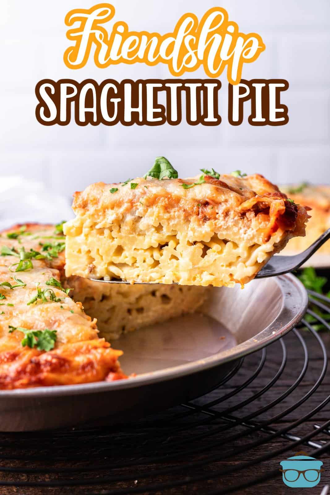 s spatula lifting up a slice of spaghetti pie out of the pan.