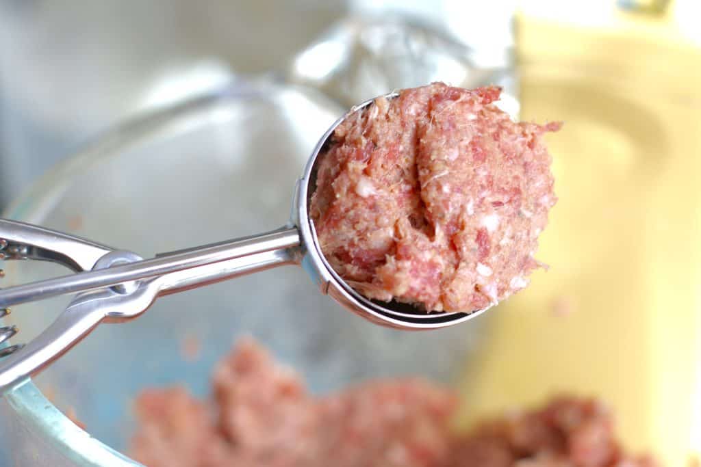 a spring loaded cookie scooper used to make round meatballs