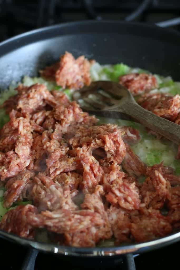 ground sausage with celery and onion in a skillet. 
