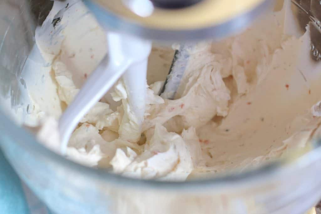 vegetable cream cheese mixed with regular cream cheese in a stand mixer.