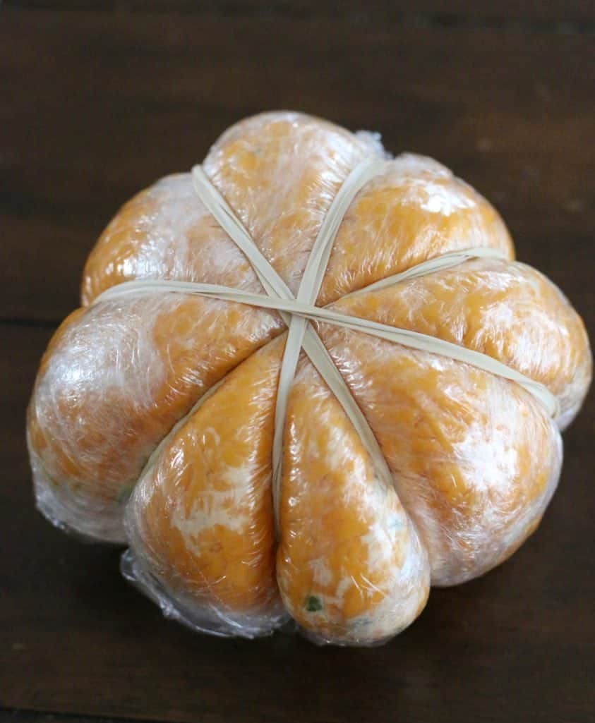 rubber band, plastic wrap cheeseball to form into a pumpkin shape.