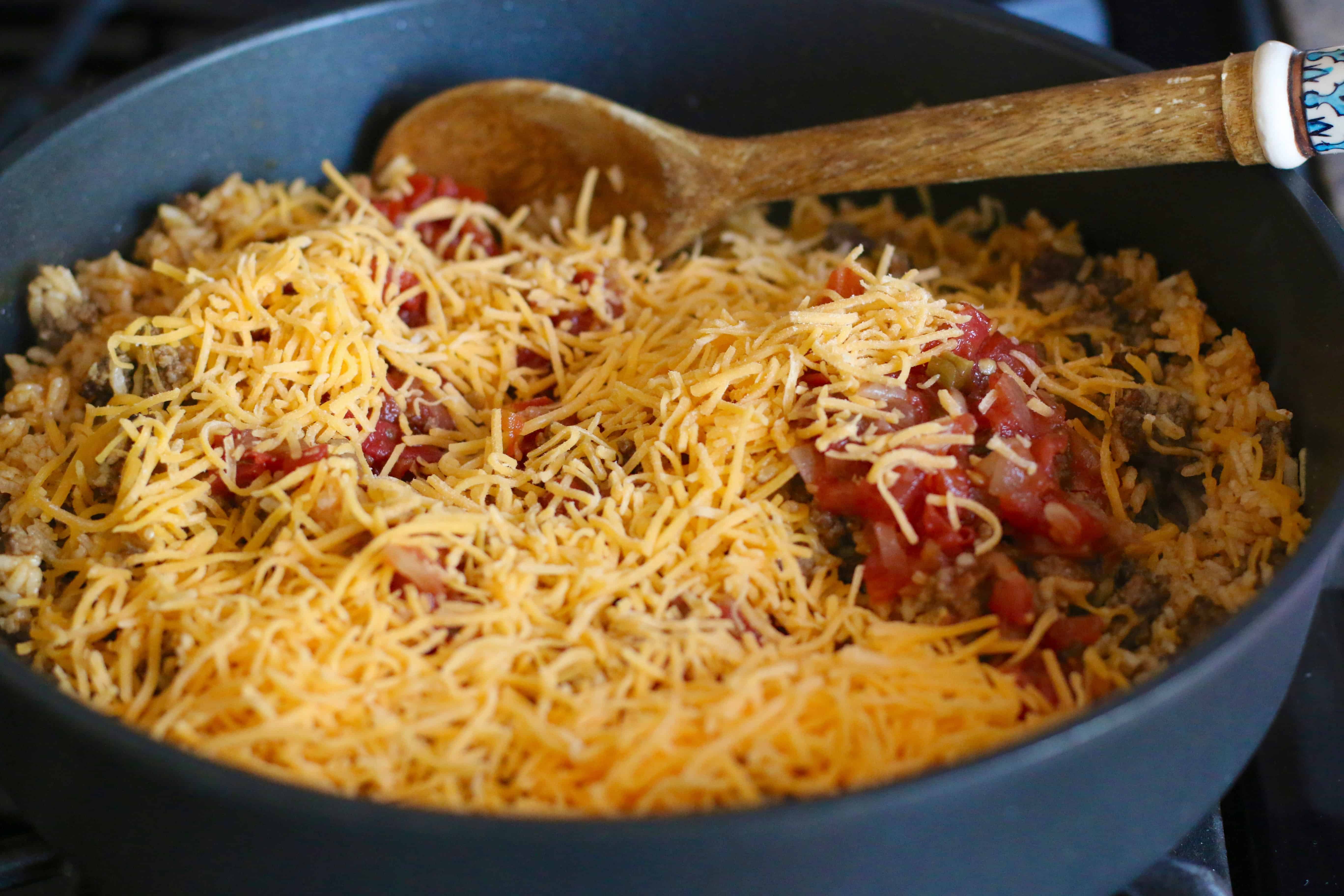 shredded cheese and salsa added to taco rice mixture in large skillet.