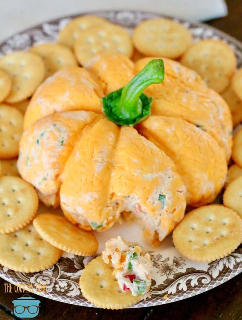 Vegetable, ranch dressing cheeseball spread on Ritz butter cracker.