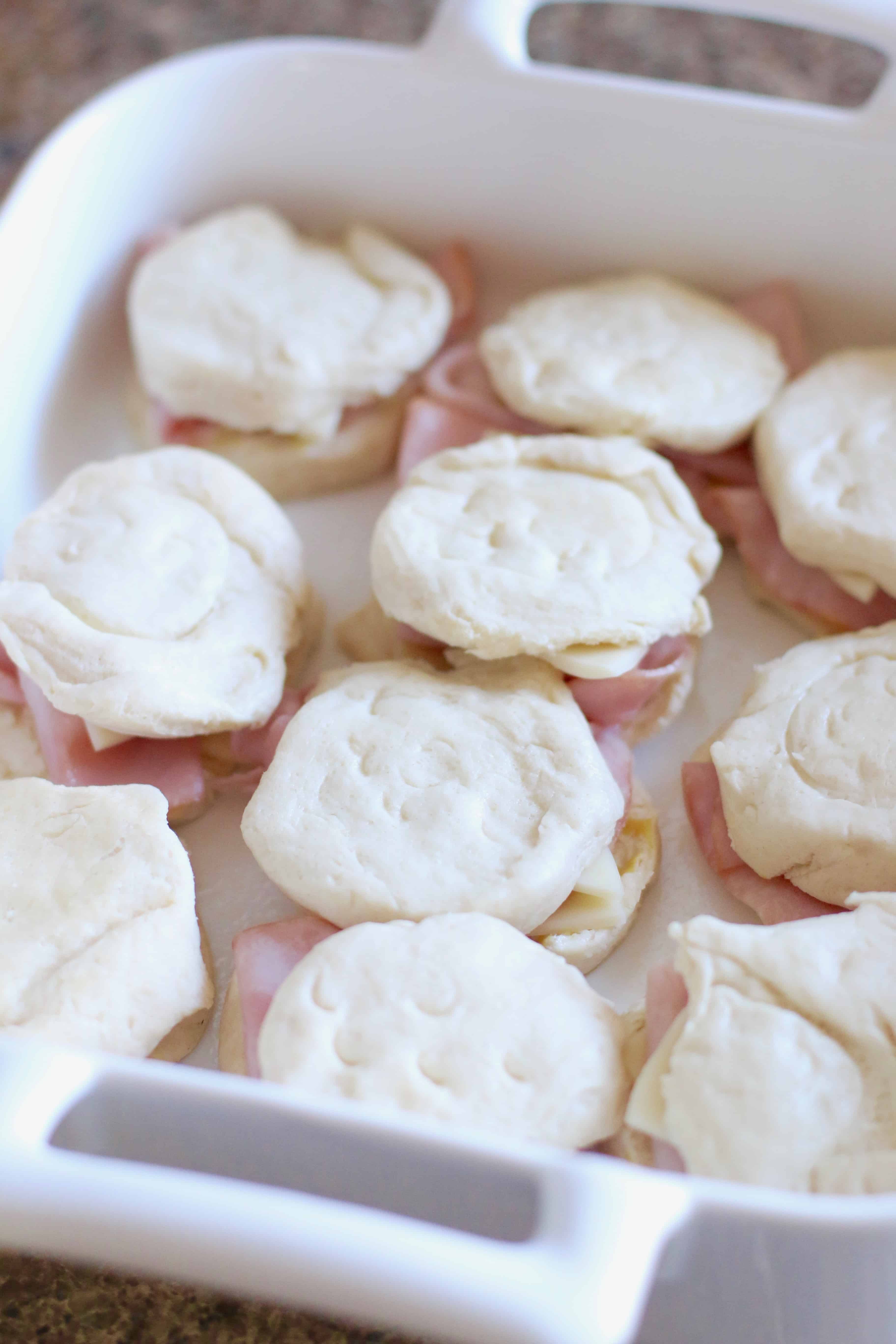 ham and cheese biscuits in baking dish, before cooking.