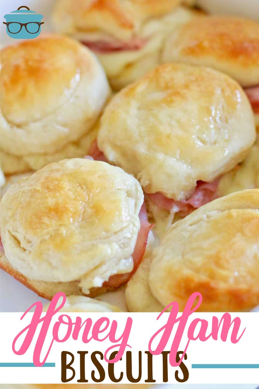 Warm Honey Ham Biscuits shown layered in a white baking dish.