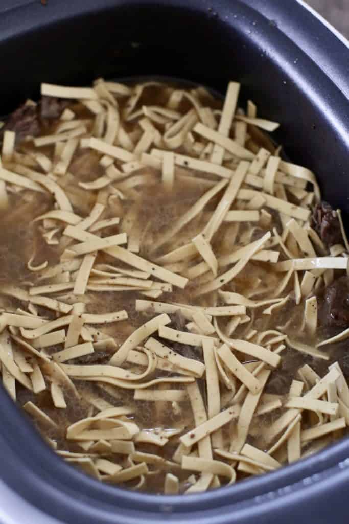dried egg noodles added to beef and broth mixture