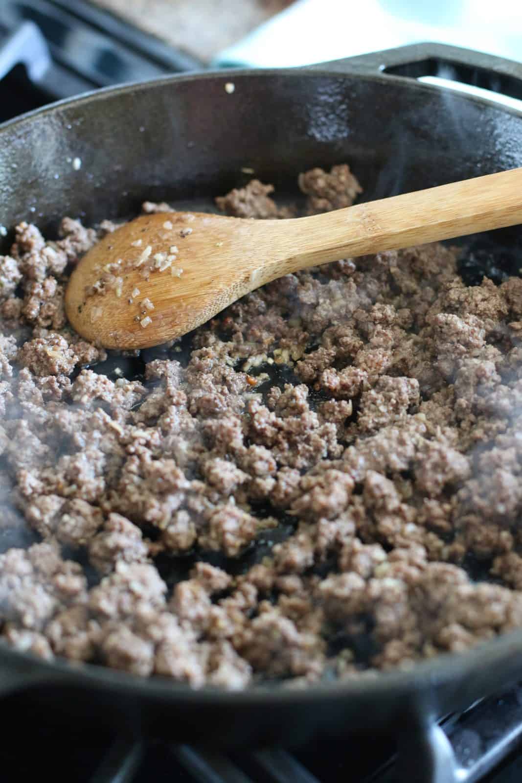 cooked and crumbled ground beef in a skillet.