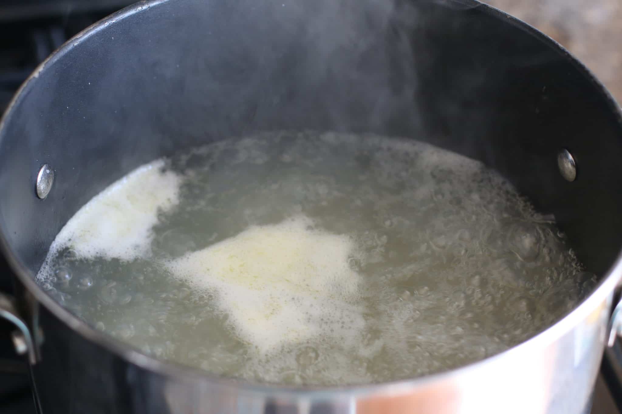 boiling macaroni noodles in a large pot.