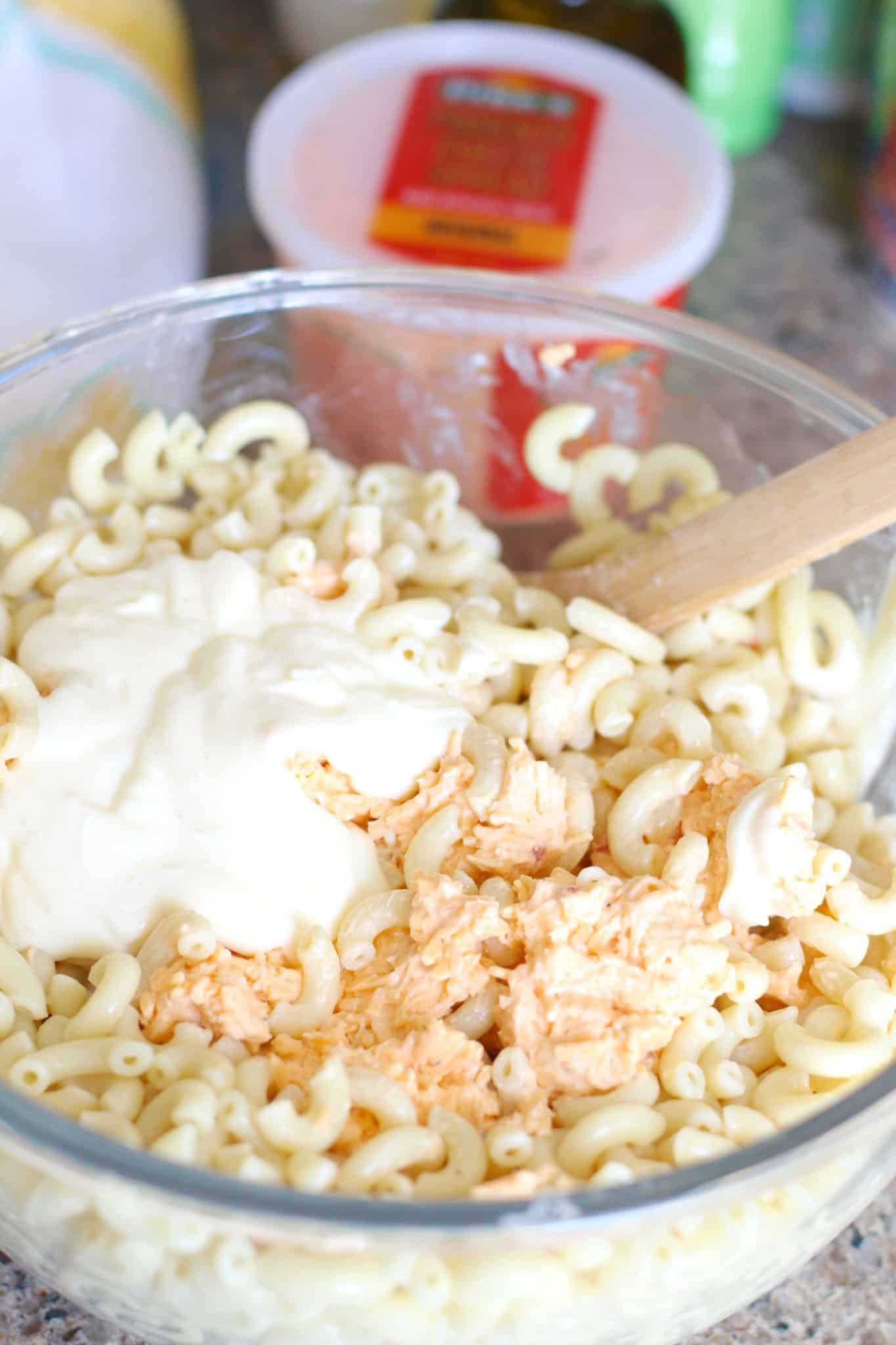 pimiento cheese, mayonnaise, macaroni noodles mixed in a bowl.