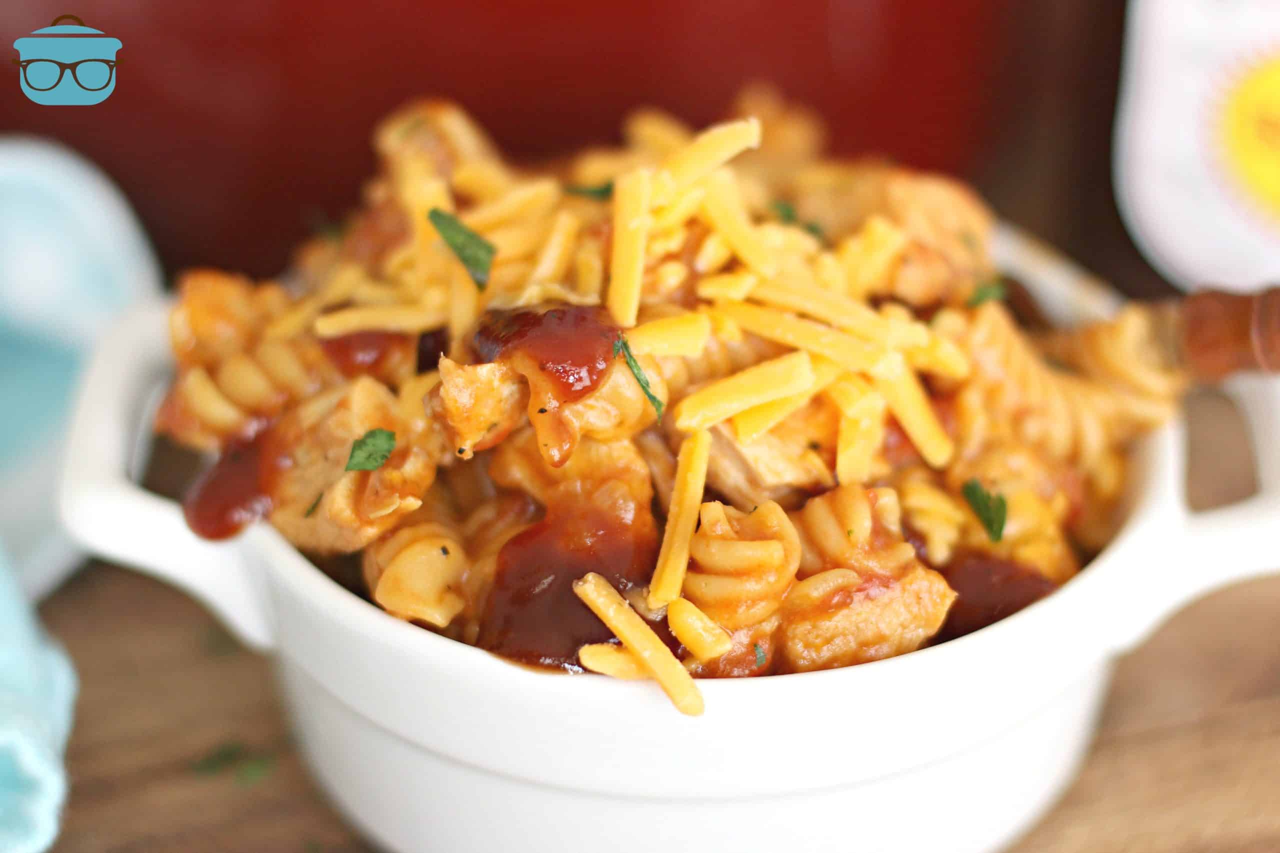 One Pot BBQ Chicken Pasta in a serving bowl with shredded cheese.