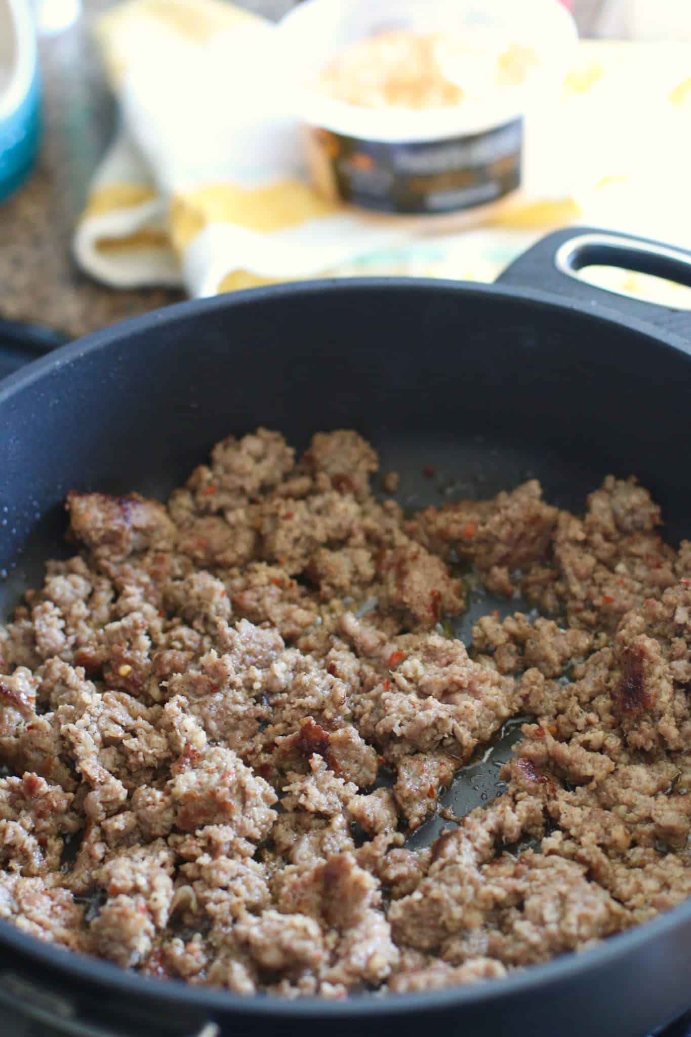cooked ground crumbled sausage in a skillet.