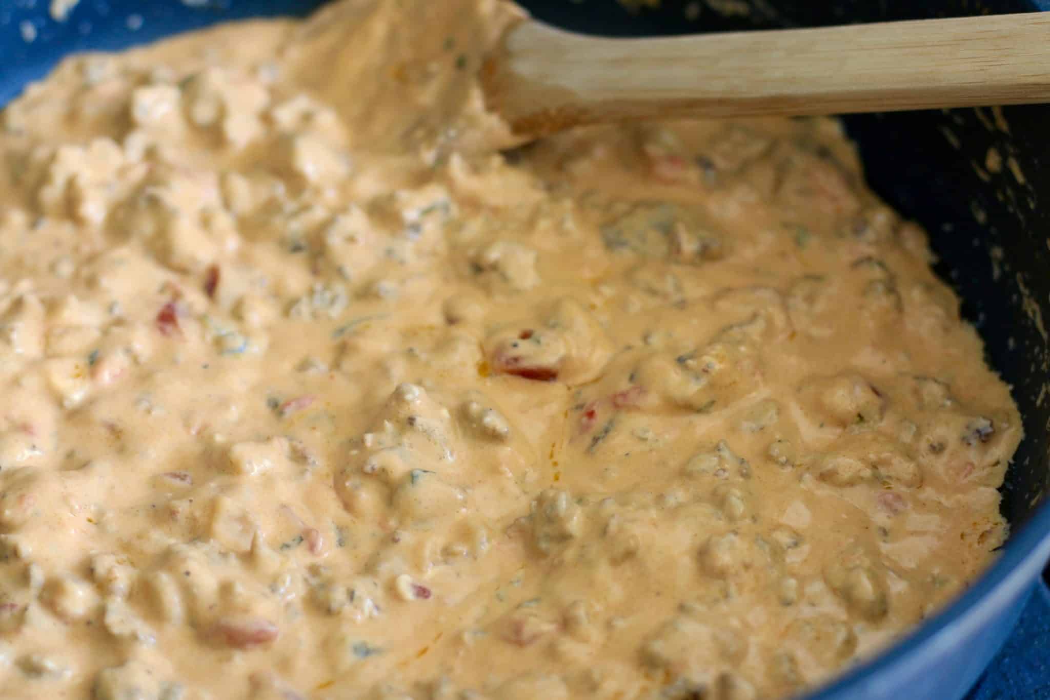 melted sausage cheese dip shown in a skillet. 