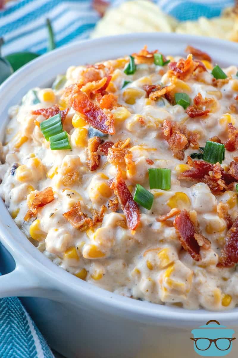 Creamy Jalapeno Corn Dip topped with sliced green onion and crispy bacon bits.