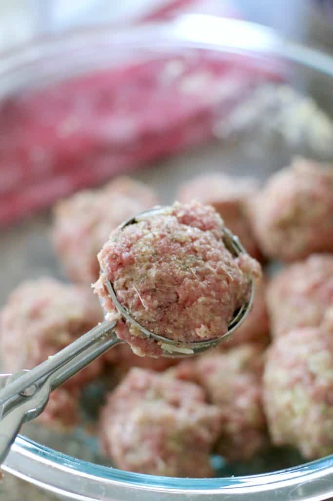 meatballs being formed using a spring-loaded scooper