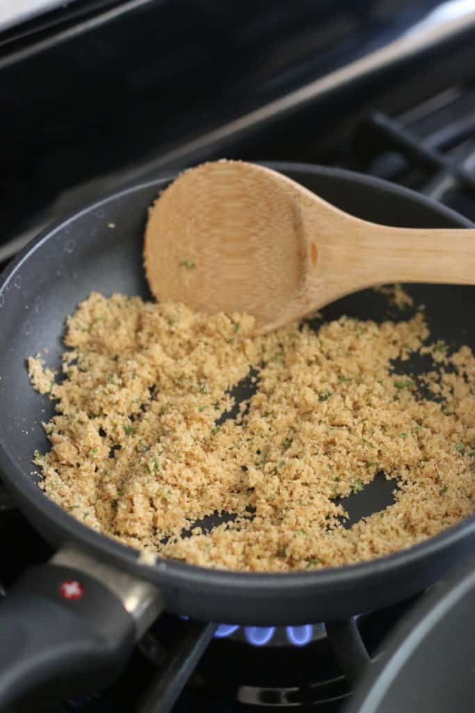 butter and bread crumbs in a small skillet on medium heat