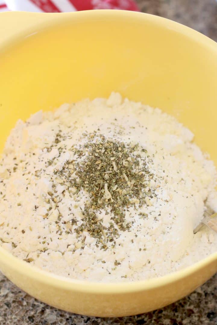 flour, parmesan cheese and baking powder in a yellow bowl