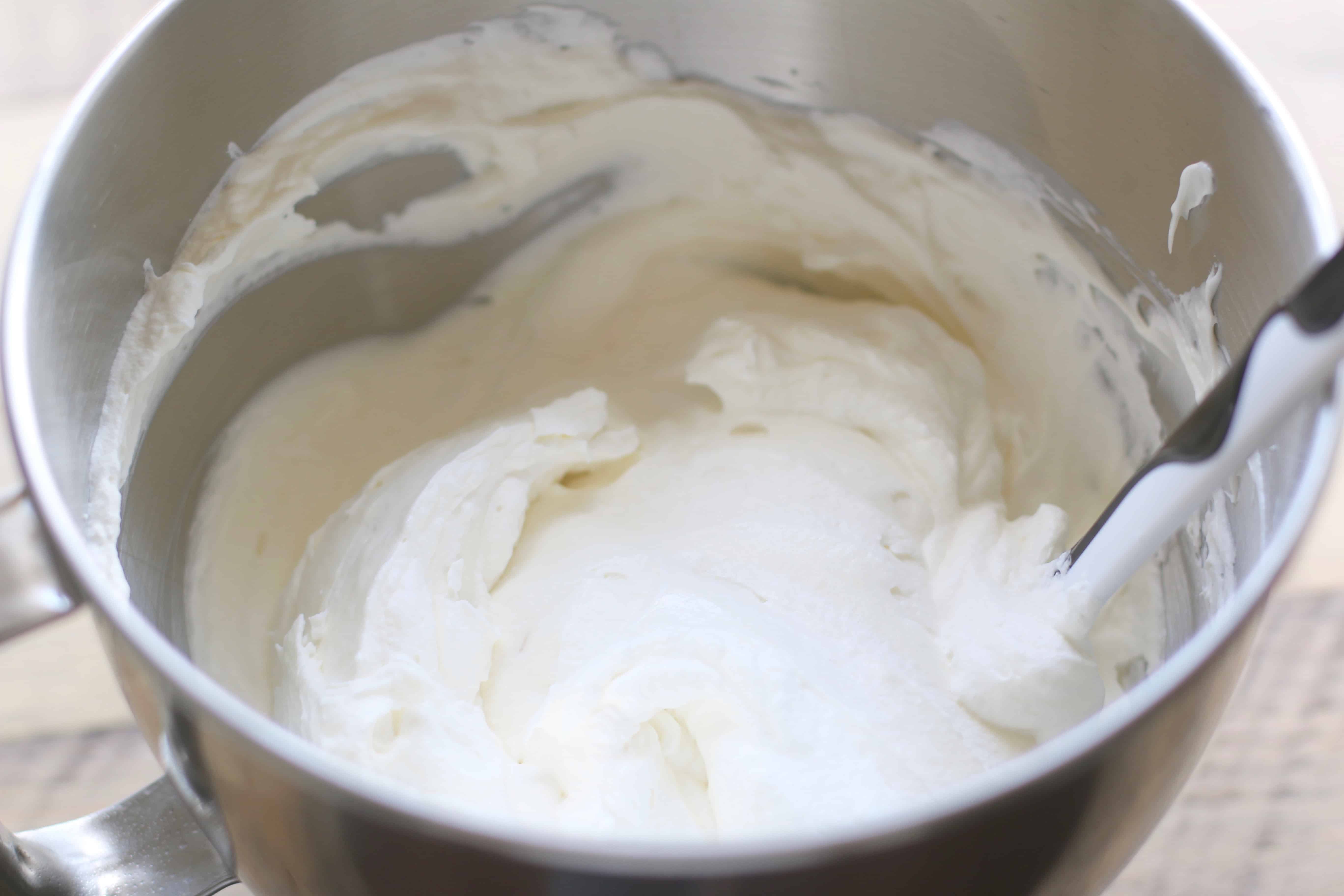 homemade whipped cream combined with whipped sweetened cream cheese in a large bowl.