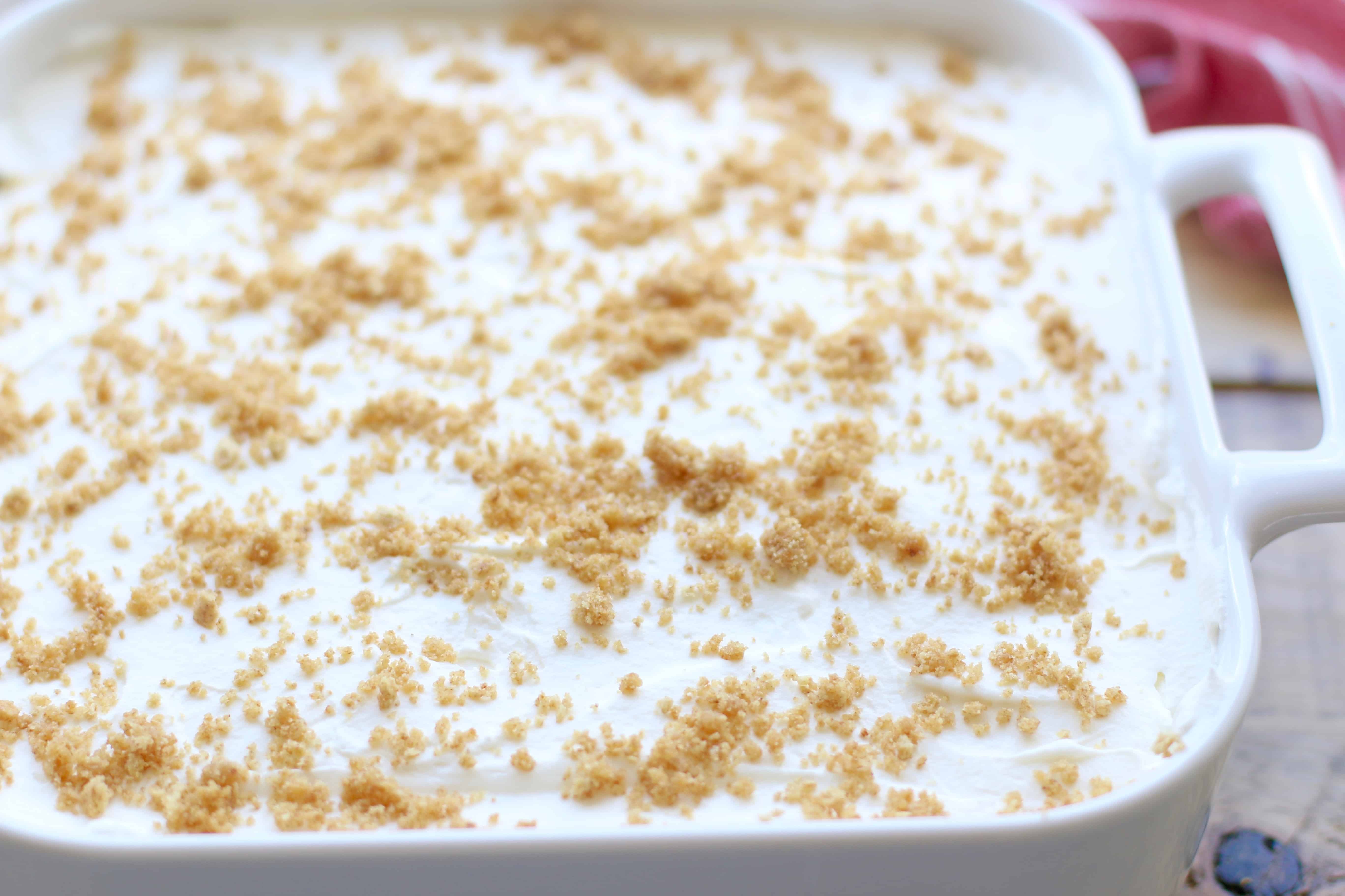 graham cracker crumbs spread on top of finished no bake apple yum yum dessert.