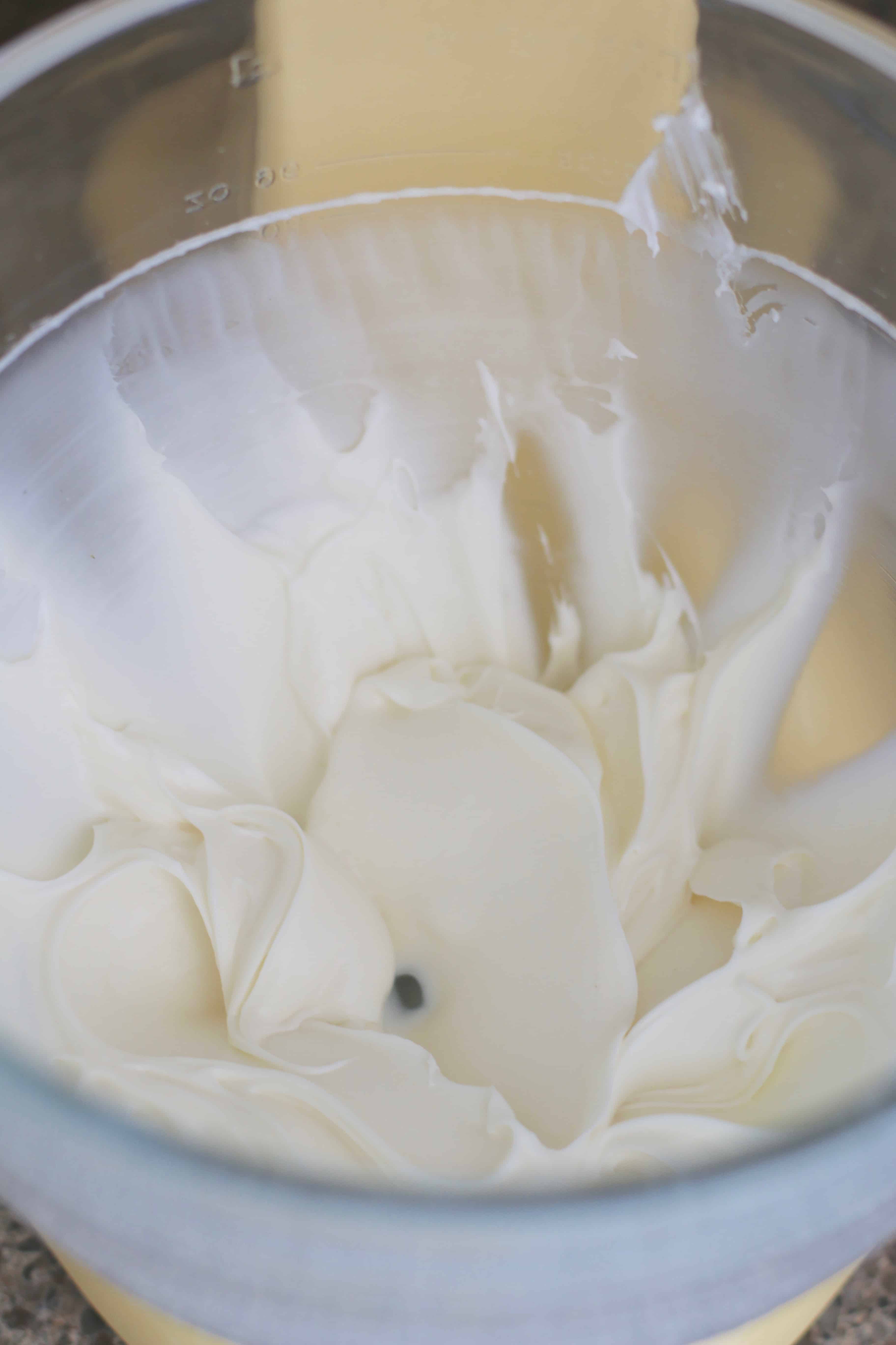 cream cheese and sugar whipped together in a stand mixer bowl.