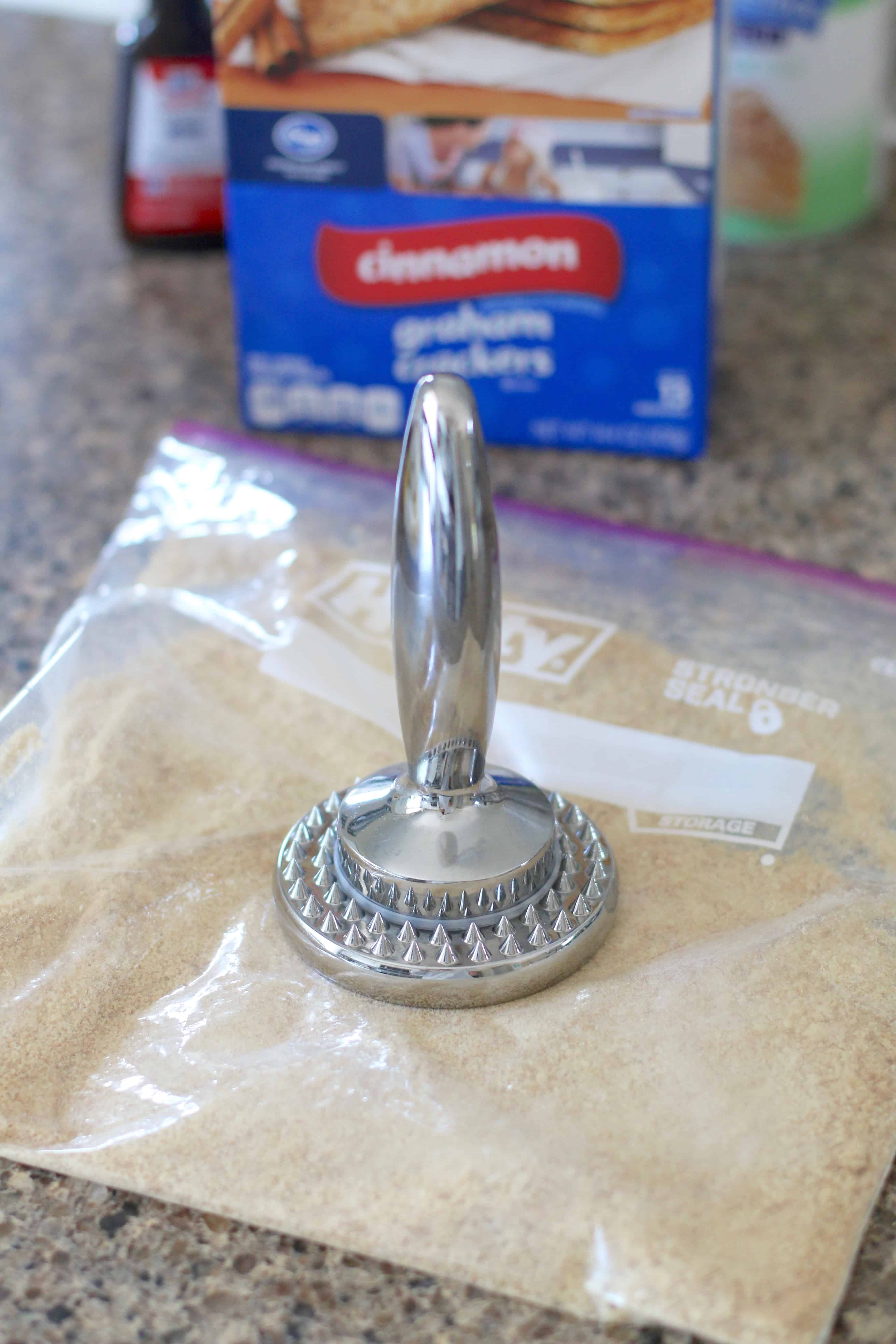 making graham cracker crumbs in a ziploc bag.