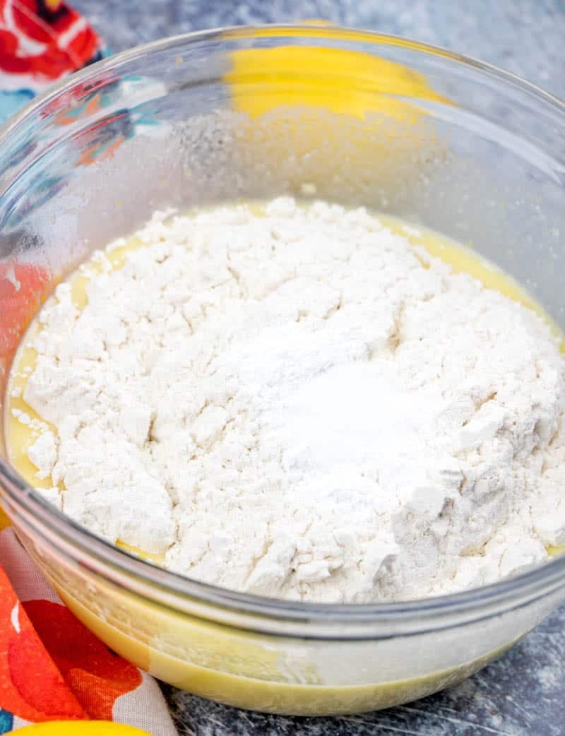 all purpose flour added to lemon loaf batter in a clear bowl.