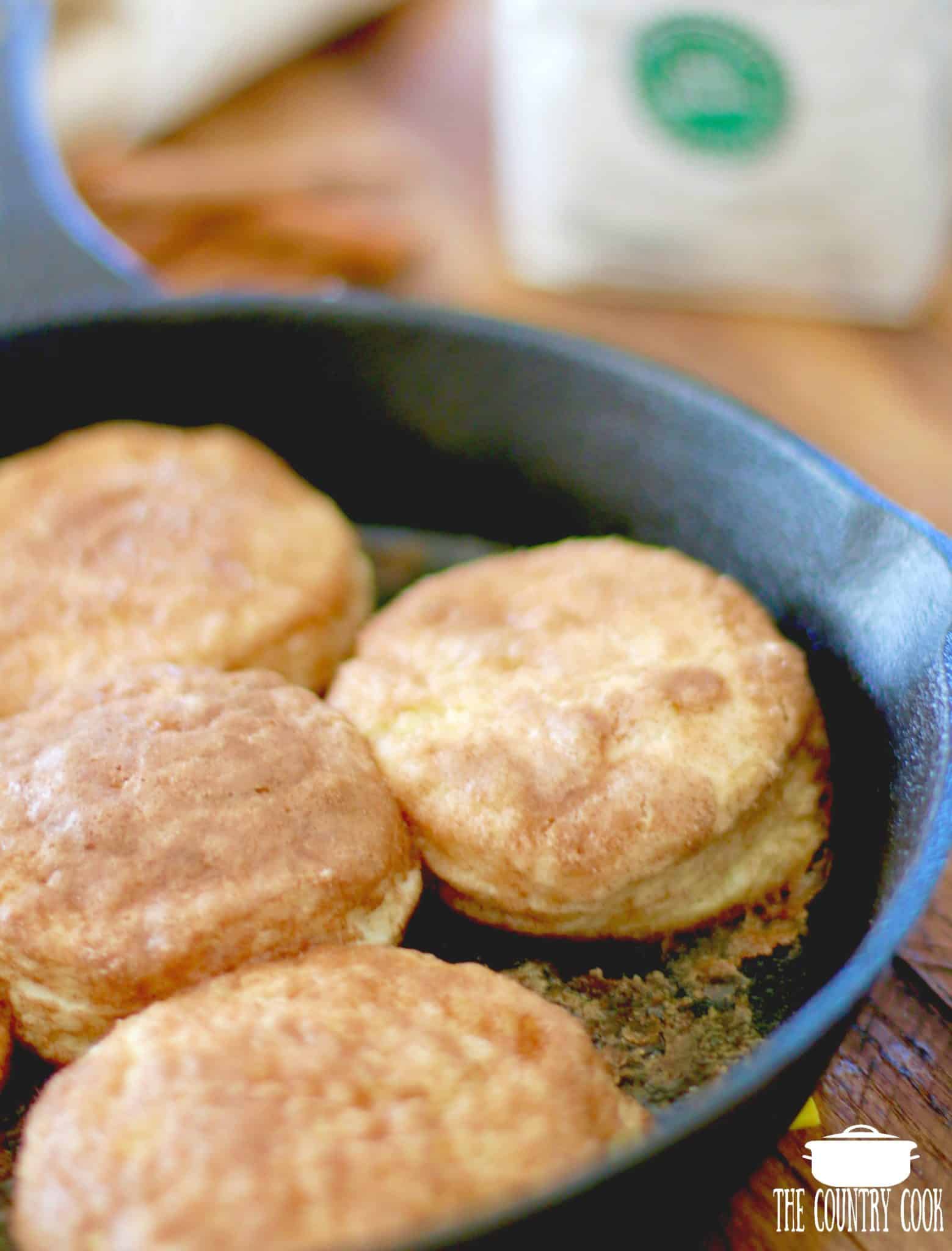 fully baked biscuits in a cast iron skillet.