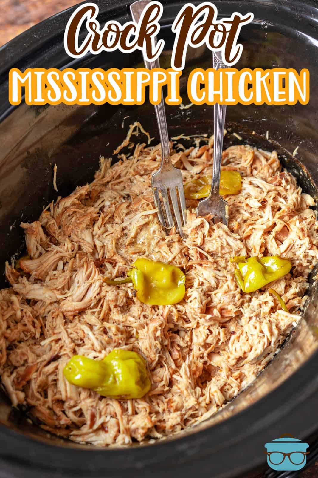 Crock Pot Mississippi Chicken shown shredded in a slow cooker with pepperoncini peppers.