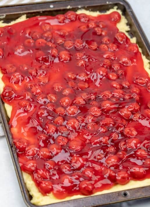 cherry pie filling on top of sugar cookie batter.