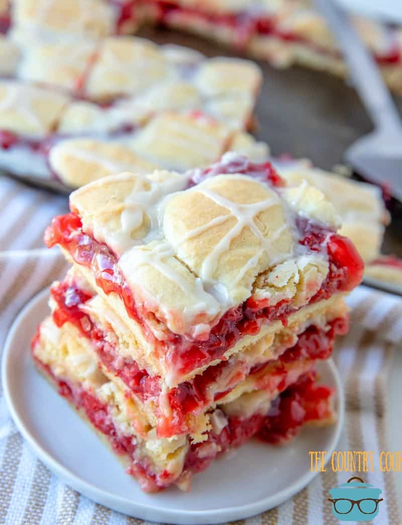 Cherry Pie Bars, stacked, on a small white plate.