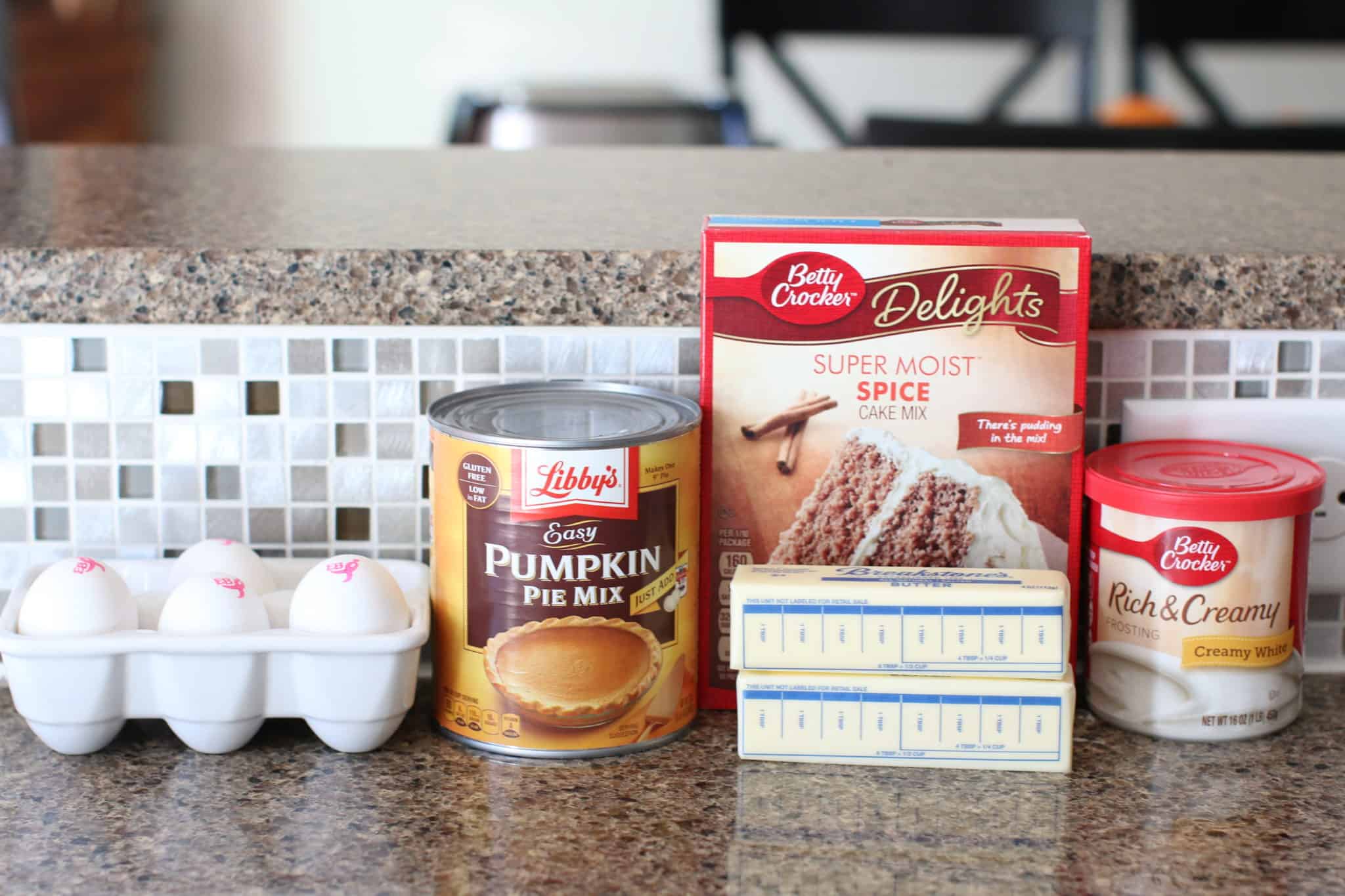 ingredients needed: boxed spice cake mix, eggs, pumpkin pie filling, butter, tub of vanilla frosting.