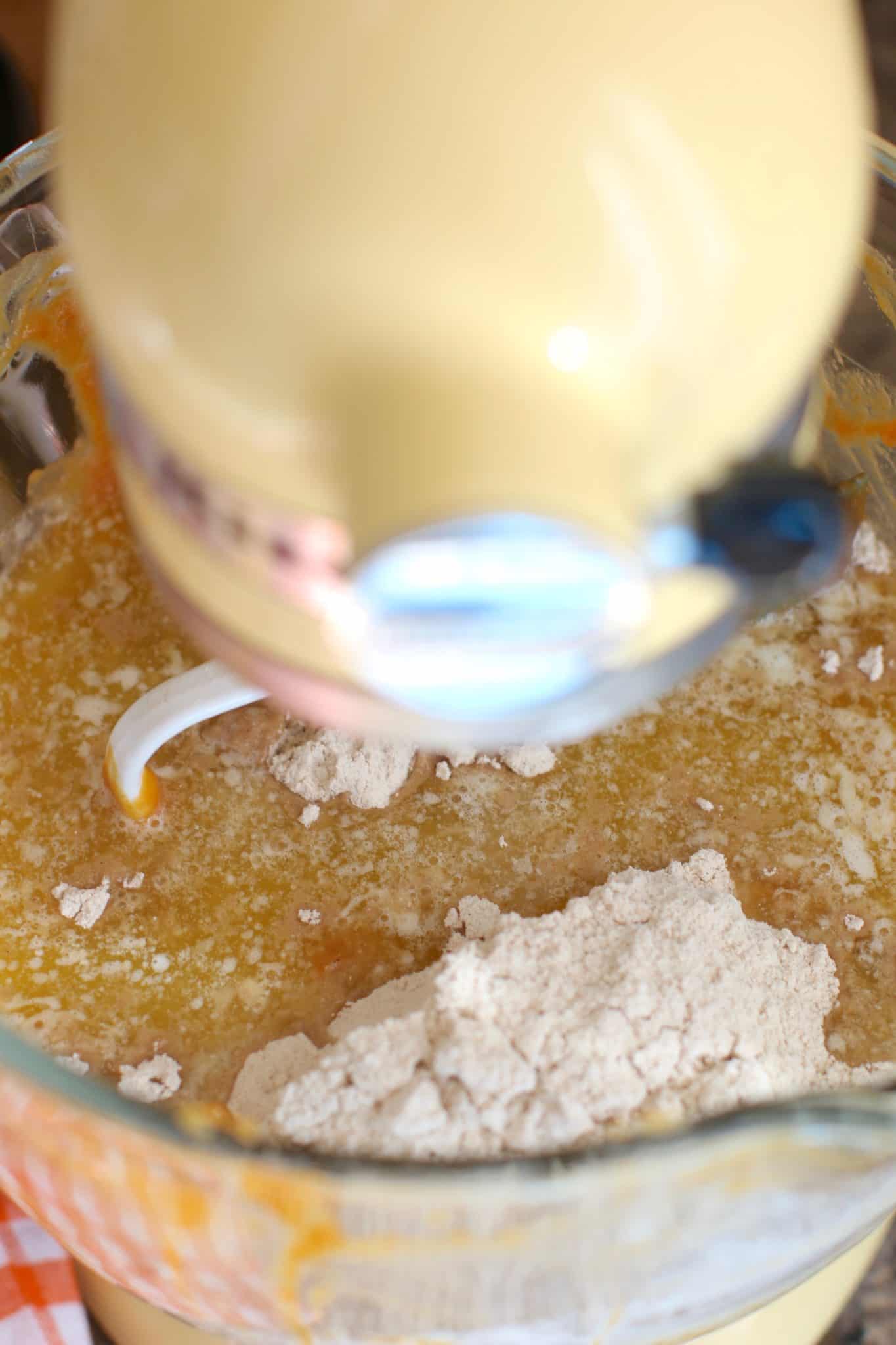 boxed spice cake mix combined with eggs and pumpkin pie filling in the stand of an electric stand mixer.