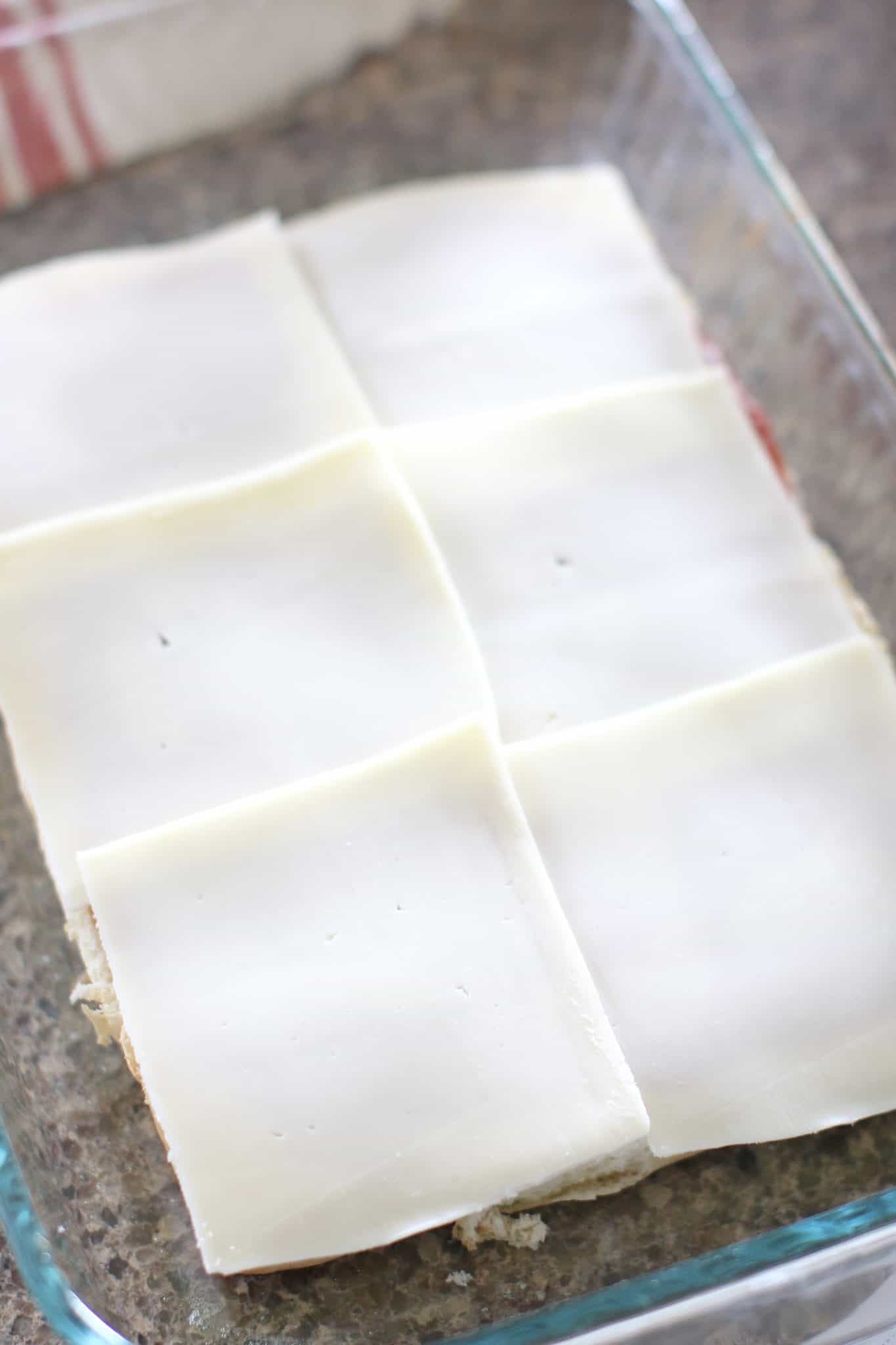sliced mozzarella cheese placed on rolls.