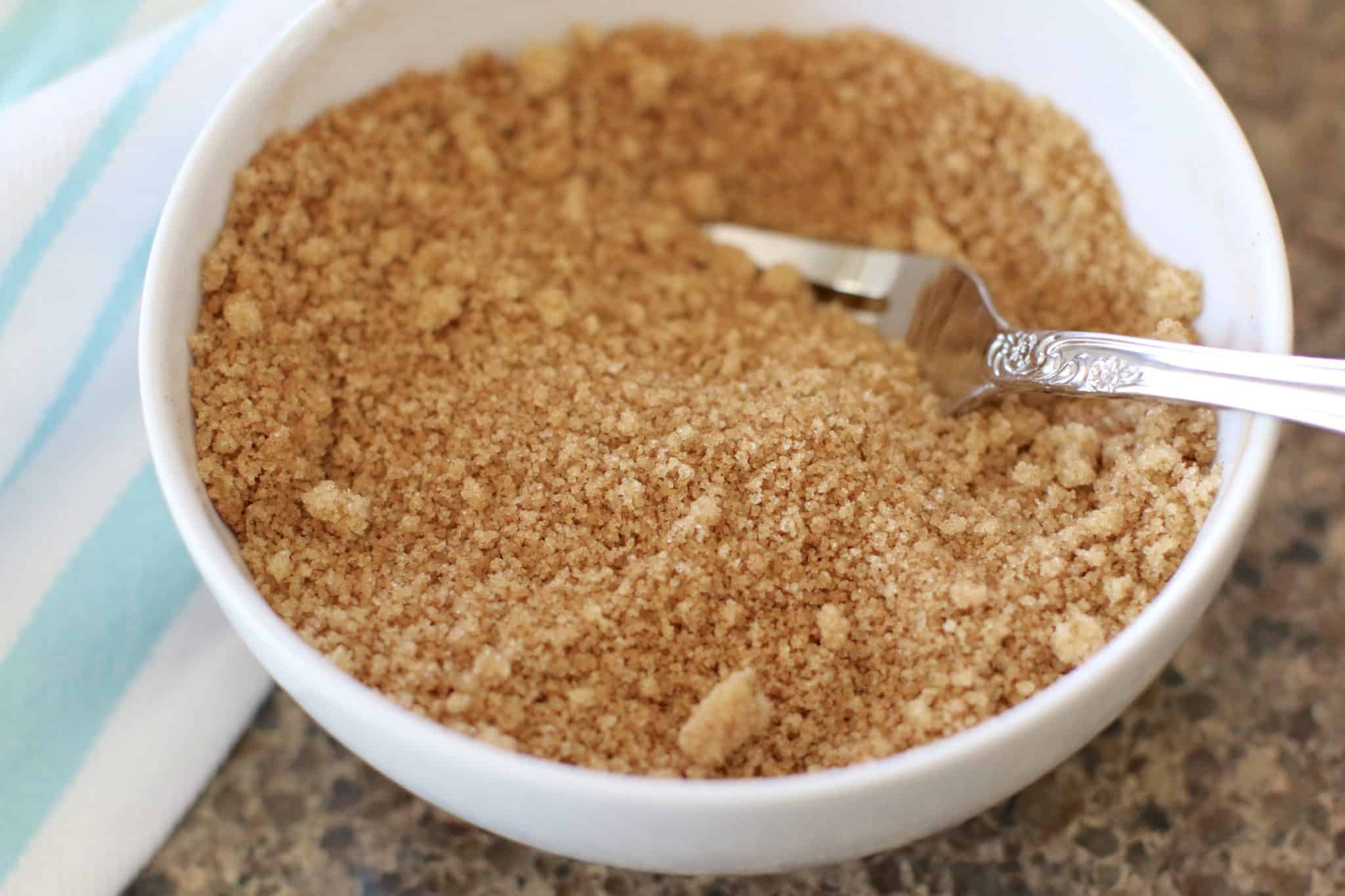brown sugar and ground cinnamon mixed together with a fork in a small white bowl.