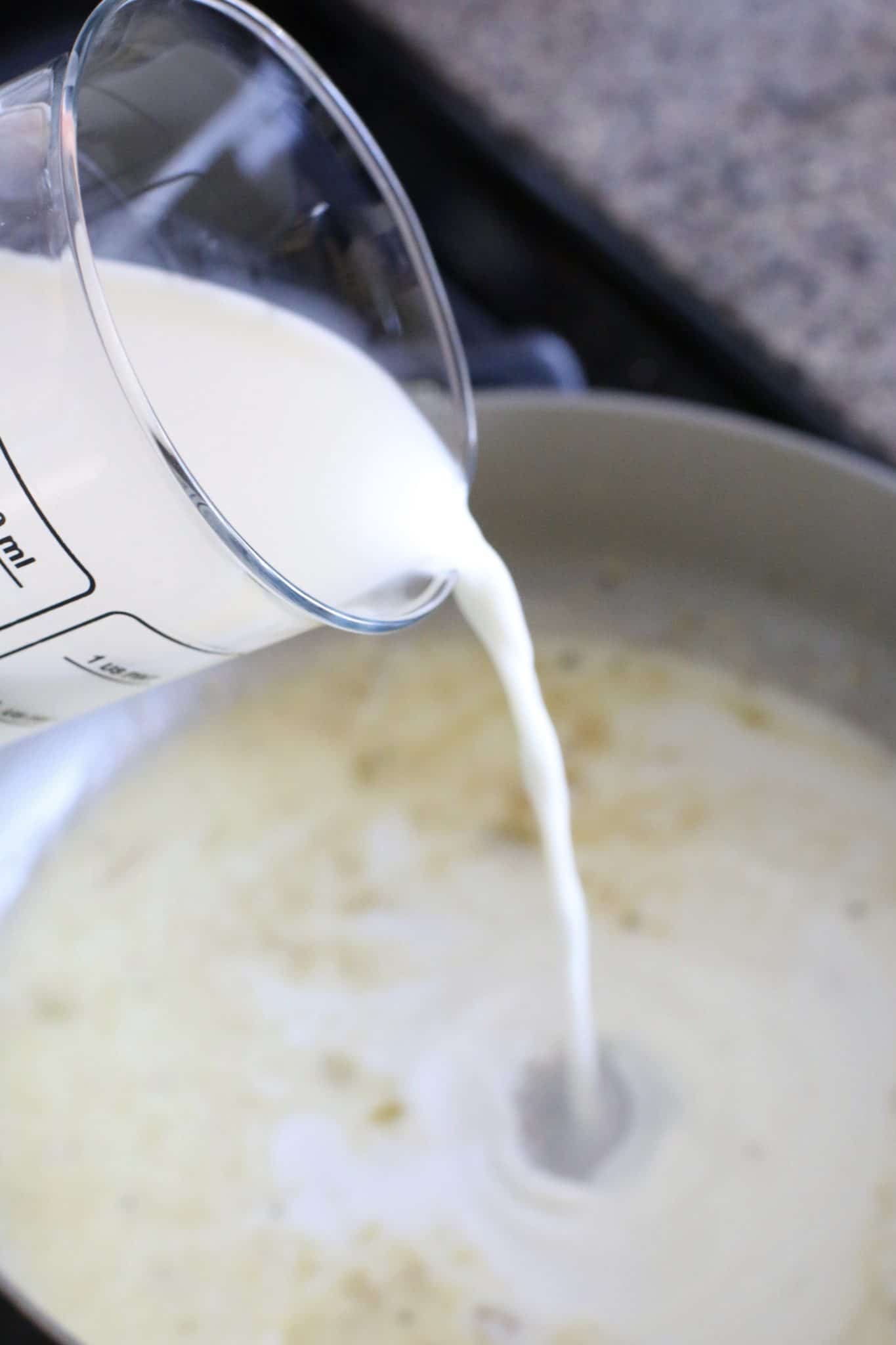 pouring milk into a pan. 