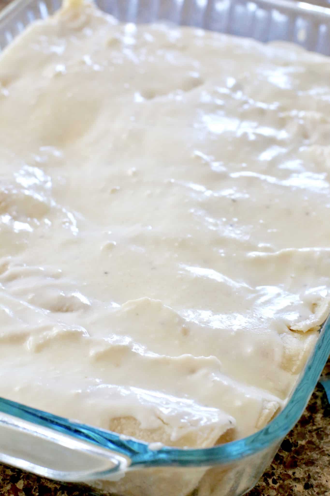 cream sauce mixture poured over rolled up tortillas. 