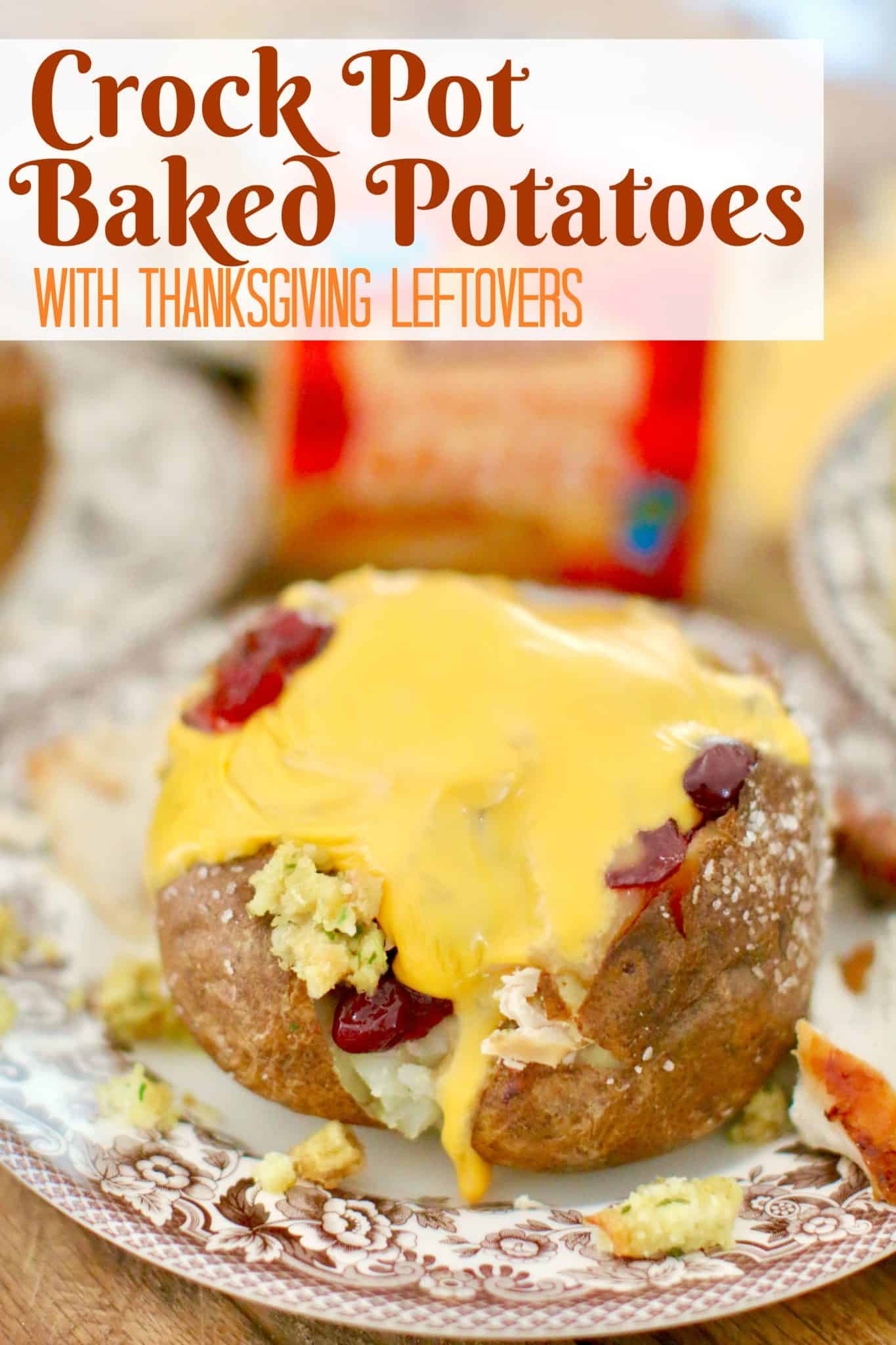 CROCK POT BAKED POTATOES with Thanksgiving Leftovers recipe from The Country Cook. Fully cooked baked potato stuffed with Thanksgiving leftover food on a round plate.