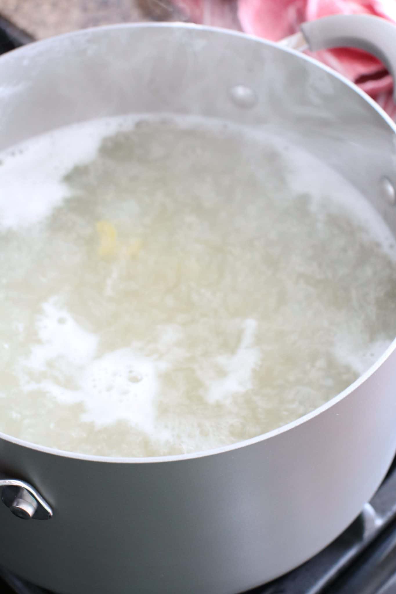 elbow macaroni boiling in water in a large pot
